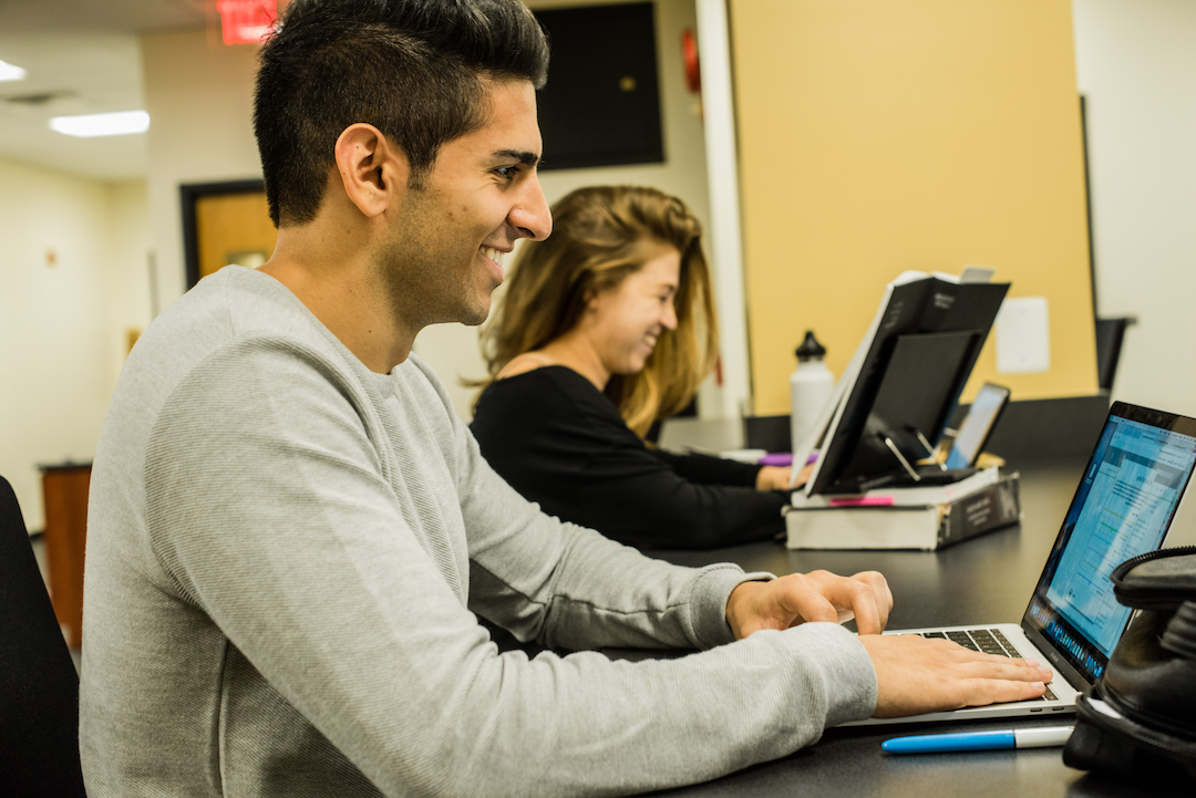Student working on computer in the library
